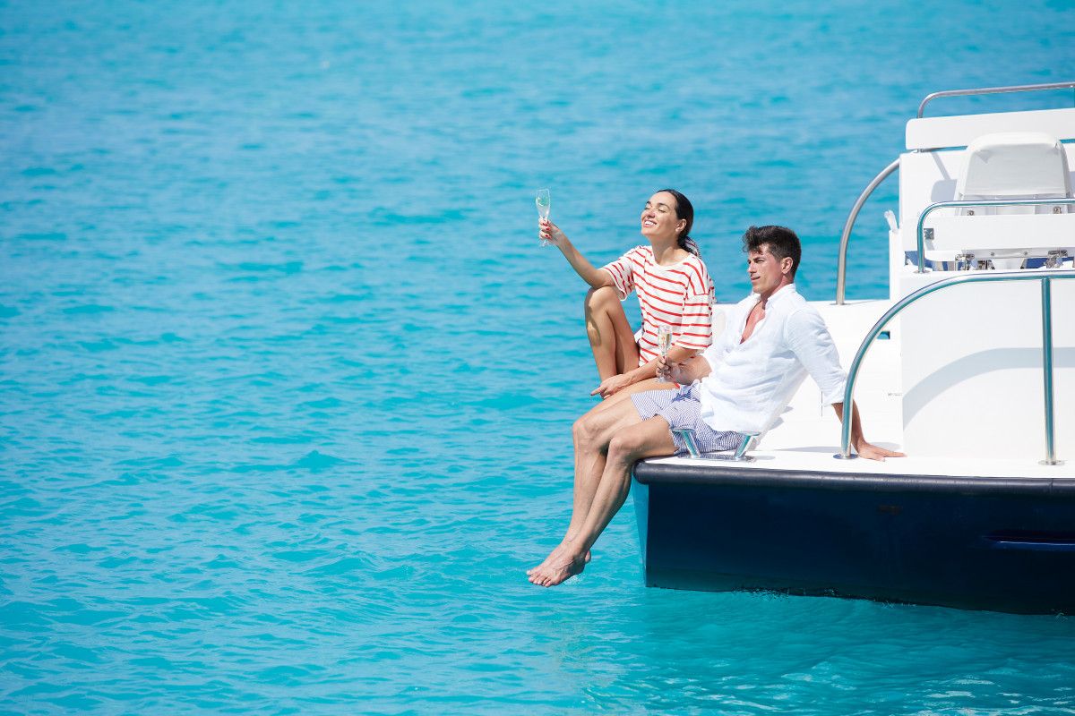 Couple toasting with Champagne aboard a private yacht in the Maldives