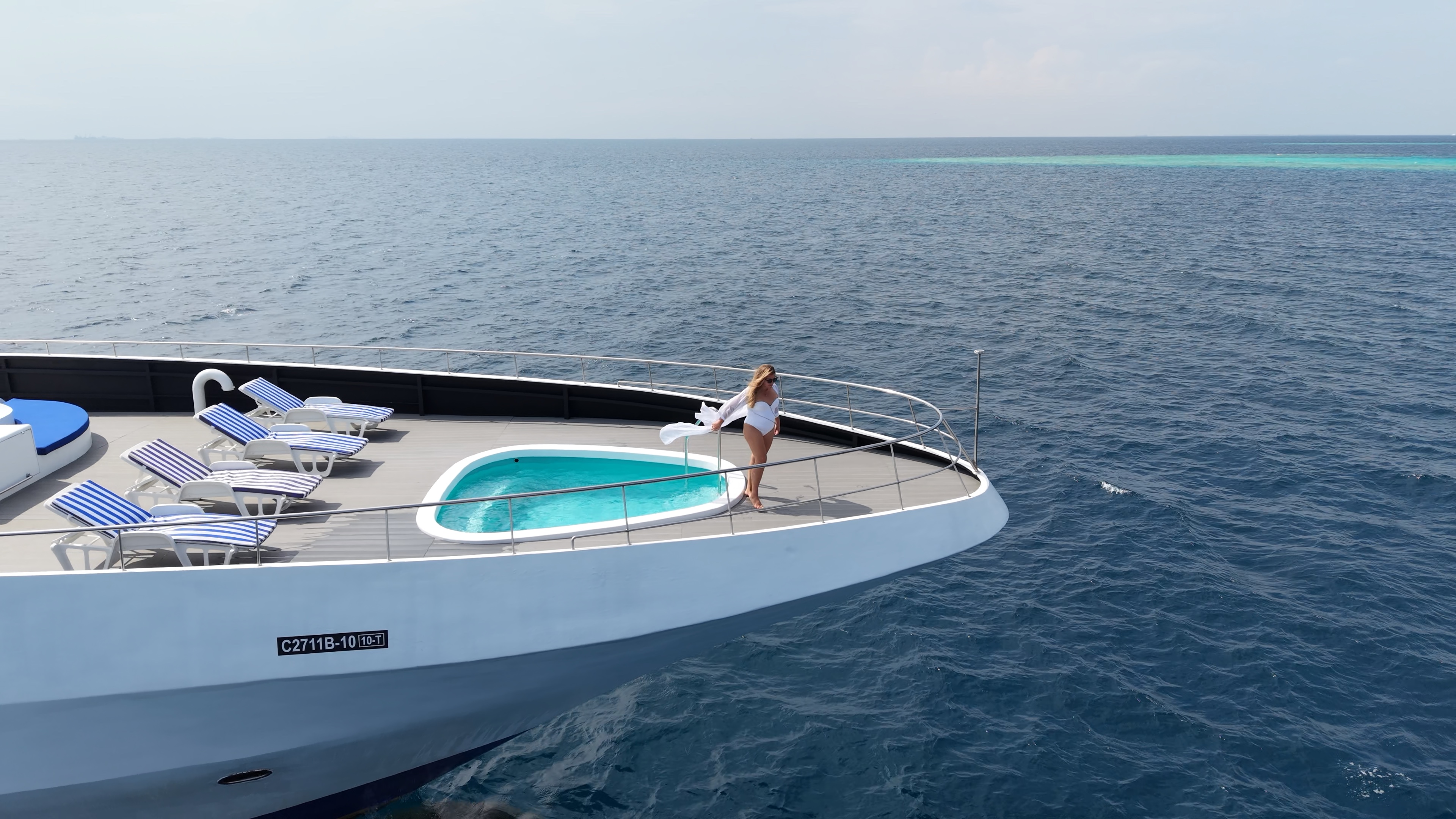 Private luxury yacht anchored over turquoise water in the Maldives for a day charter