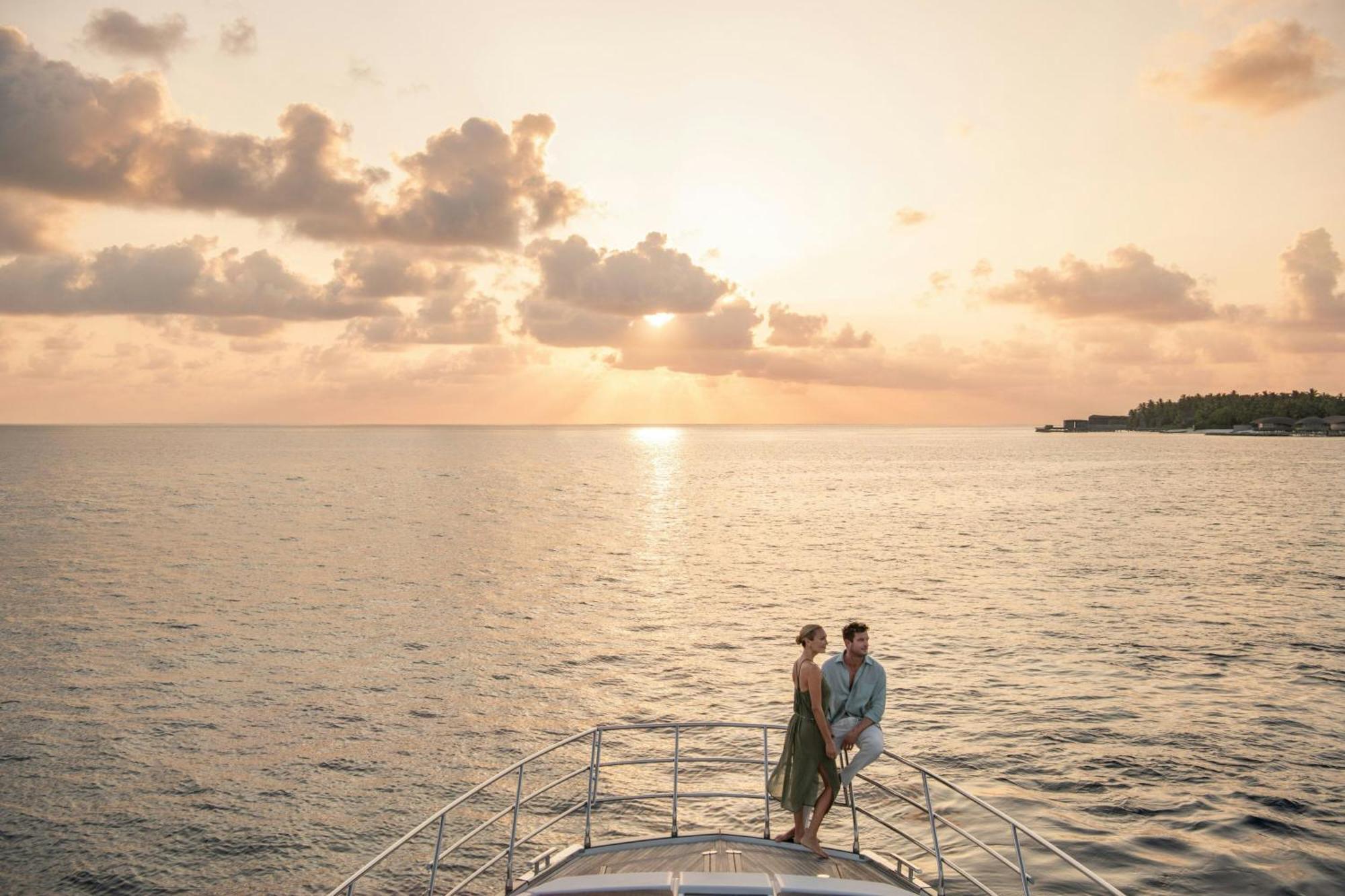 Private yacht anchored in a quiet Maldives lagoon at golden hour