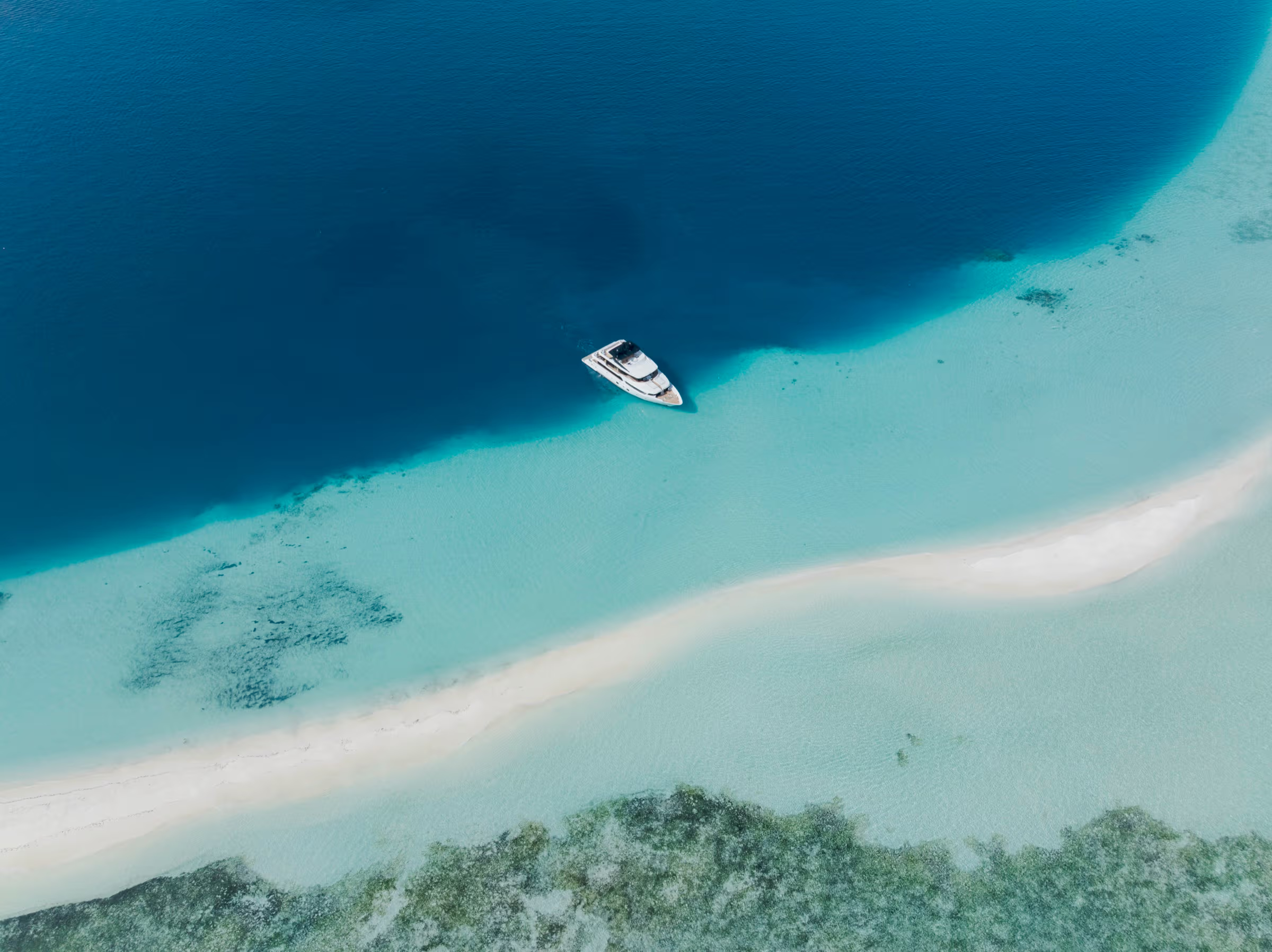 Guests stepping aboard a private luxury yacht for a day charter in the Maldives