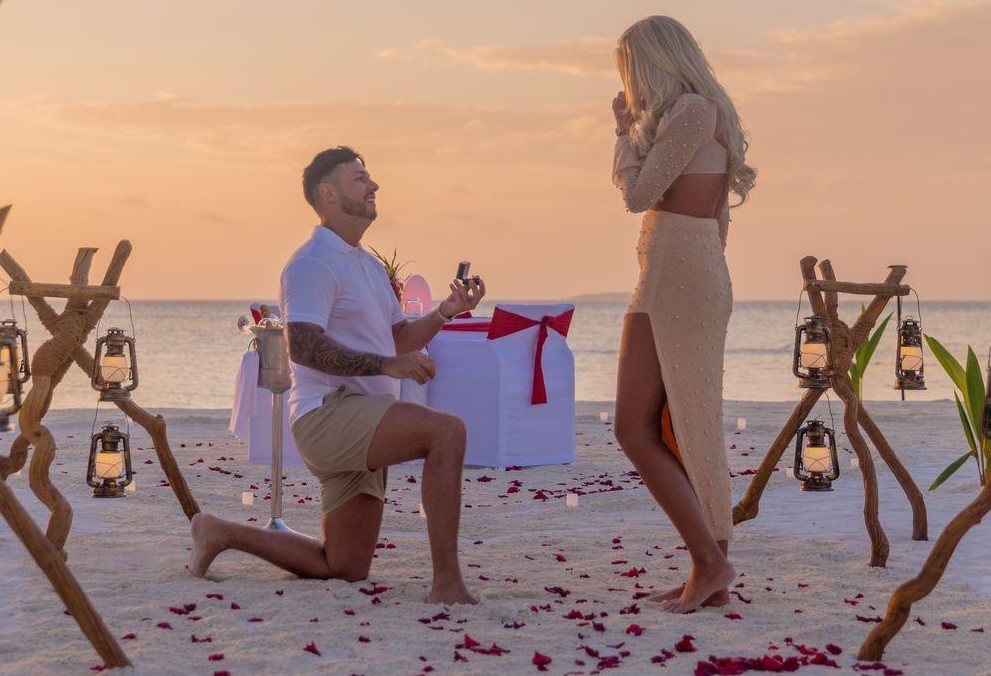 Couple at sunset on a private sandbank in the Maldives during a proposal cruise