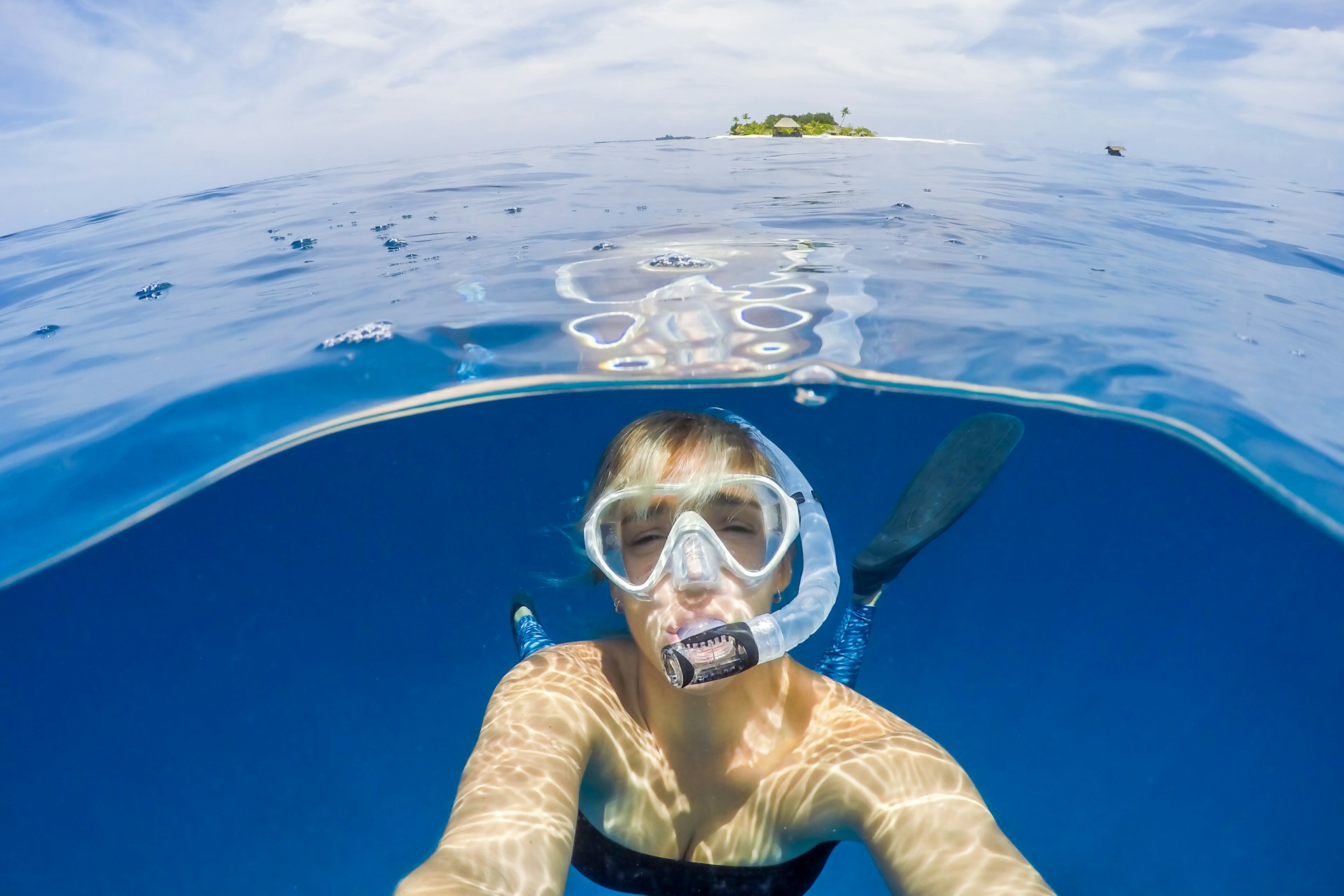 Snorkelling the reef beside a Maldives sandbank