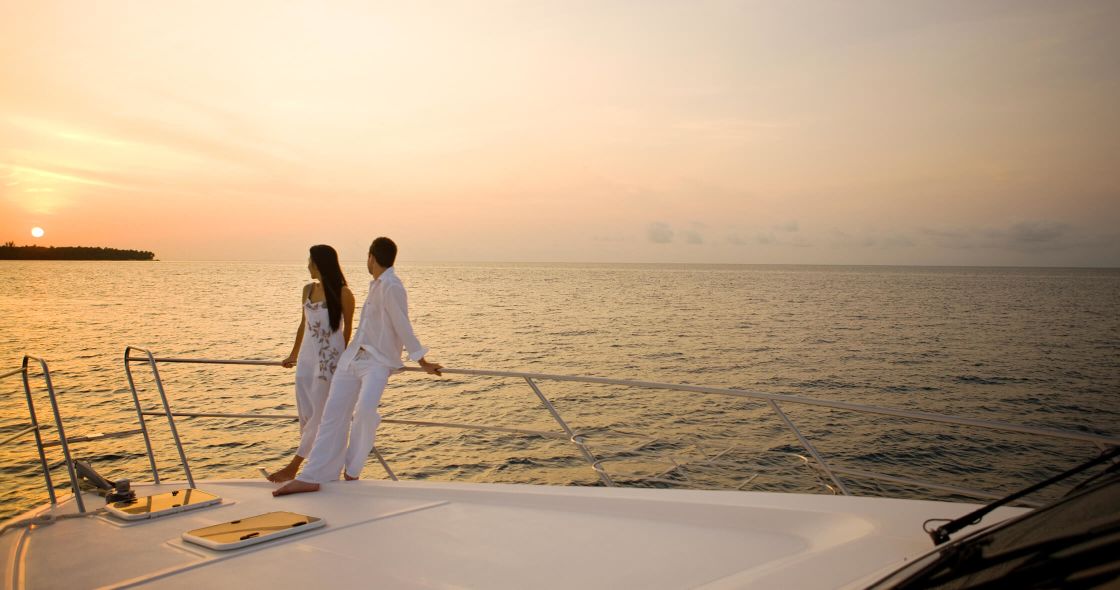 Canapés and drinks on a yacht deck at sunset in the Maldives